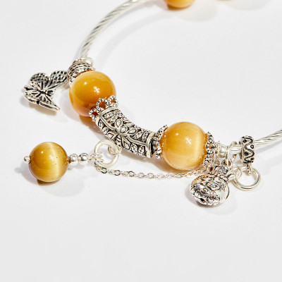 Vòng tay phong thủy nữ đá mắt hổ vàng tâm charm bướm 10mm mệnh thổ , kim - Ngọc Quý Gemstones